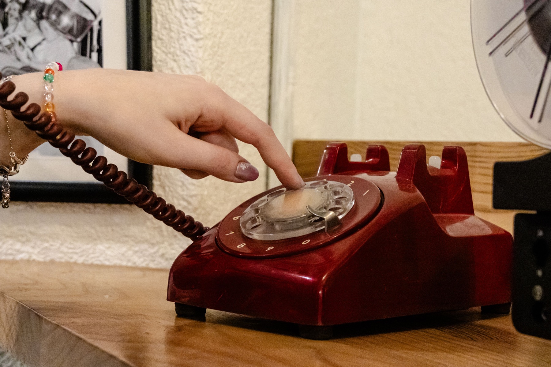 A hand using an old rotary phone, used as a metaphor for repeated hotel website friction